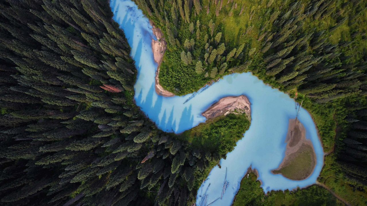 Photo Contest 2018 Caption: An aerial view of the Holmes River, British Columbia, Canada. Photo Credit: © Shane Kalyn/TNC Photo Contest 2018Photographer’s Statement: "River Runs Through It." As we flew over the beautiful Holmes River, the glacial waters contrasted nicely with the forest - the waters extra blue due to increased glacial melt. 
